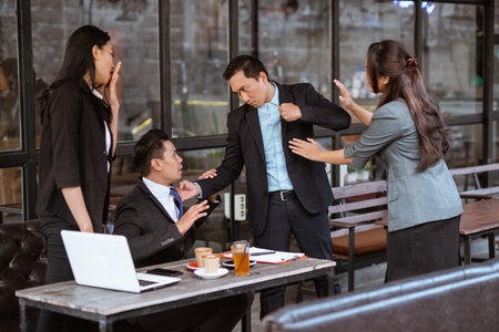 portrait of asian business partner fighting each other during meeting.