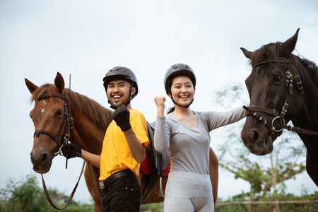 two equestrian athletes ride horses and start training in outdoor backgroundの写真素材