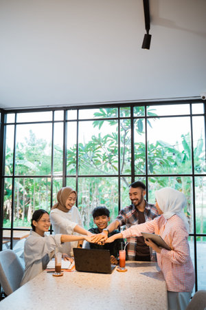 group of asian students with hand gesture symbol of unity when together in cafeの写真素材