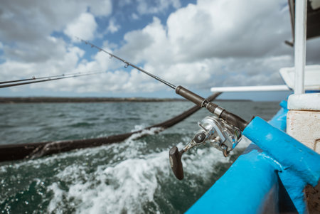 fishing rod mounted on a small fishing boat while sea fishingの写真素材