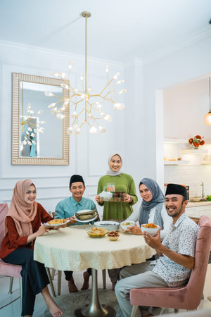 portrait of happy family look at camera together in the dining room when breaking fast