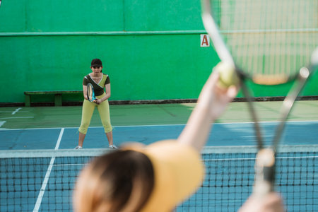 selective focus tennis player with stance ready to receive the ball from the opponent on the tennis courtの写真素材