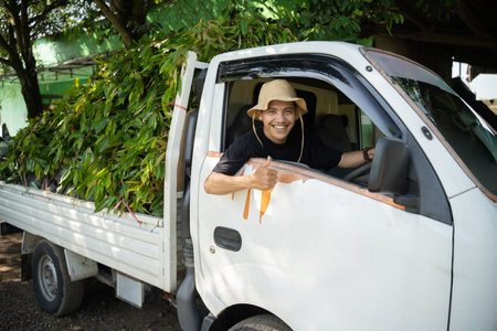 Male farmer brings seeds to sell in a transport car at the nurseryの写真素材