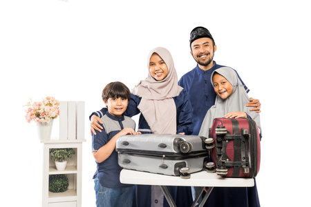portrait of muslim asian family with suitcase going for eid mubarak holidayの写真素材