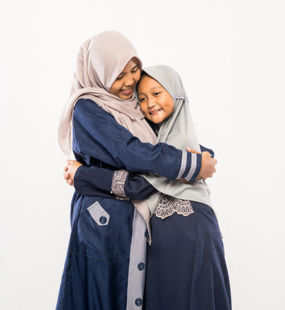 beautiful asian family with daughter wearing traditional islamic clothes over white backgroundの写真素材
