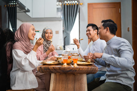 portrait of asian happy friends having dinner at home togetherの写真素材