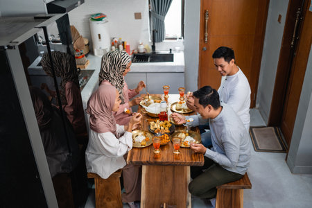 portrait of asian happy friends having dinner at home togetherの写真素材