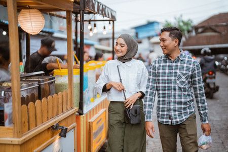 couple walking down the street looking for snacks food before breaking the fast
