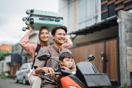 asian muslim family riding motorbike scooter together traveling with kid. eid mubarak travel conceptの写真素材