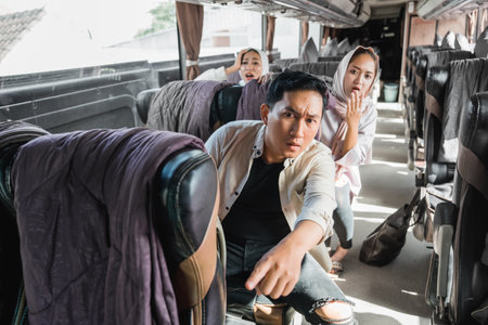shocked passenger pointing to the front while sitting on a busの写真素材
