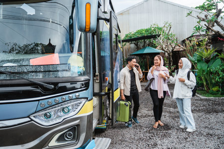 happy asian muslim passengers lined up in line to get on the bus