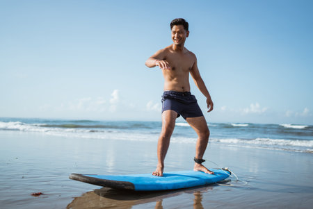 one person practicing surfing during summer vacation on the beach on the sandの写真素材