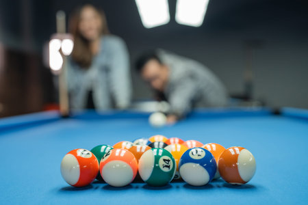 fifteen billiard balls neatly arranged on the billiard table before the game started by the pool...