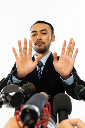 an adult man in blue shirt and black suit with navy tie dodged while proffered by a lot of...