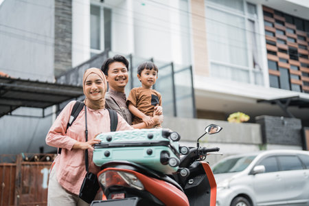 beautiful muslim family going with motorbike together during eid mubarak holiday