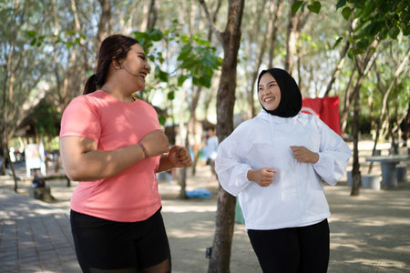 cheerful asian women enjoying sports outdoor activity together with friend