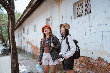 attractive Asian backpacker girl carrying a backpack confused to find a tourist destinationの写真素材