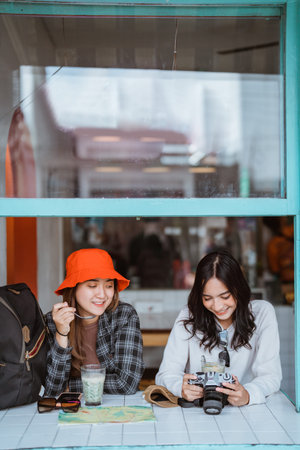 two friends enjoying es dawet, a traditional Indonesian drink, at a tourist stall