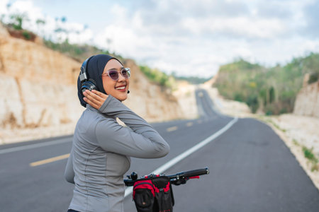 hijab woman enjoying listening to music and riding bike, biking concept