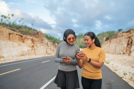 asian two girls enjoying jogging together on the road