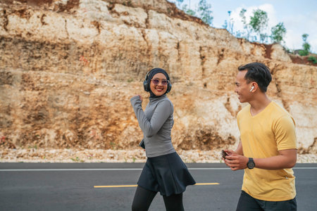 happy athletic couple running together on the road, jogging concept