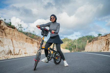 hijab woman riding bicycle on the road, biking concept