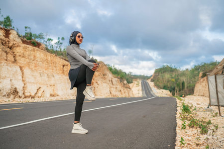 hijab woman wearing sportswear stretching before running in outdoor