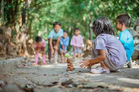 kids keeping stracked when playing traditional gamesの写真素材
