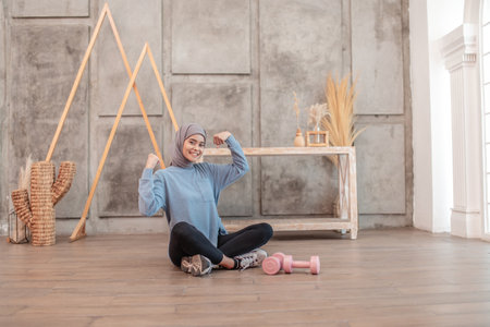 A sporty woman happily enjoying her fitness and strength training in her home studioの写真素材