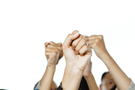 potrait of raised hands with fist pump gesture in isolated backgroundの写真素材