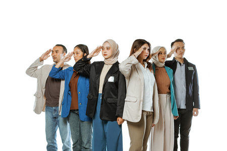 university students wearing blazer standing with salute pose in isolated backgroundの写真素材