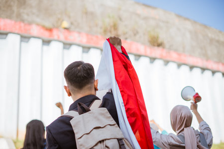 Protesters proudly display a variety of colorful flags and signs during a vibrant demonstrationの写真素材