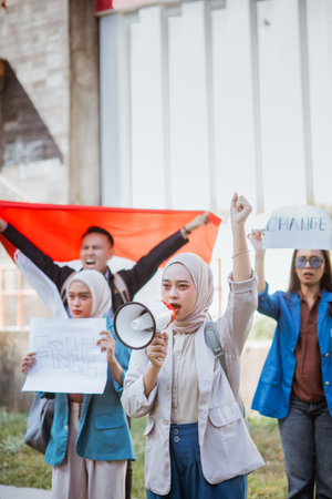 A group of young activists is fervently protesting for social justice, fairness, and equality