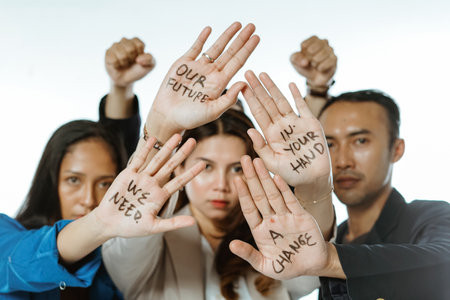 asian female and male students showing written palm motivation about futureの写真素材