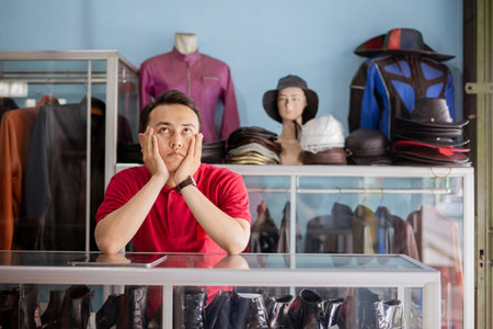 leather shoe businessman thinking and waiting customer with hands on cheek gestureの写真素材