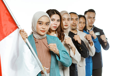 indonesian students holding national flag with fist hand gesture in isolated backgroundの写真素材