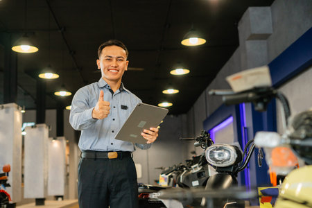 salesman standing and holding tablet with thumb up gesture