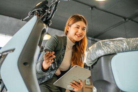 asian businesswoman working at electric bicycle store using tabletの写真素材