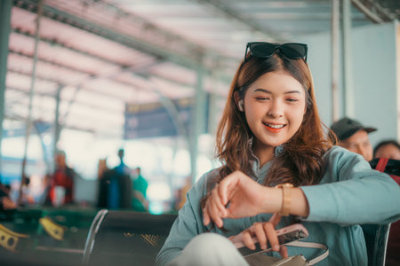 A cheerful young woman is seen at the airport, checking her watch while truly enjoying her time