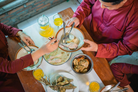 A family gathering enjoying a traditional meal with diverse dishes and refreshing drinks