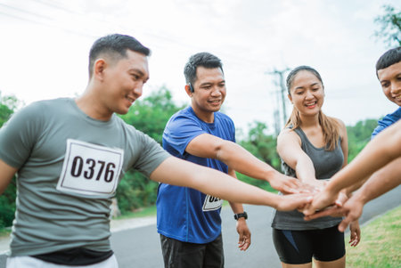 asian athlete showing their good teamwork by putting their hand together