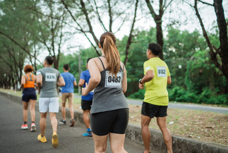 back view of marathon participant running at outdoor track