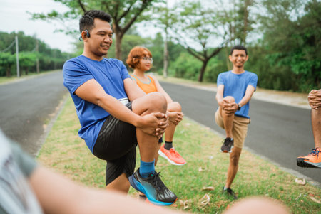 asian male runner stretching before marathon with other people