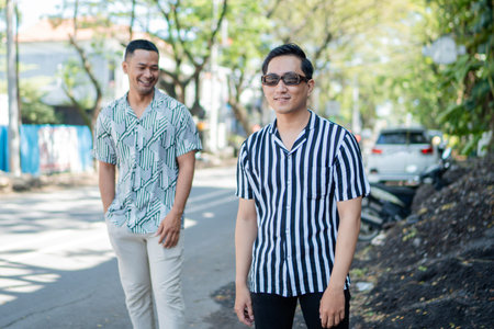 Enjoying sunny summer vibes with friends in trendy outfits on a cheerful street