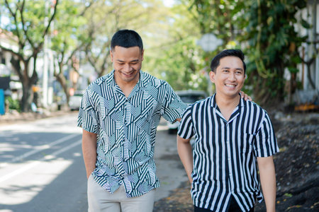 Two close friends are happily walking and laughing together in a lively urban setting