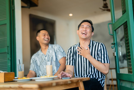 Two friends enjoying a lighthearted moment in a relaxed caf atmosphereの写真素材