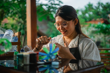 asian woman enjoy crafting plastic bottle waste, living sustainability lifestyleの写真素材