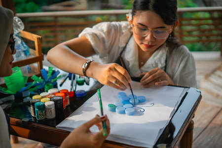 women making art using plastic bottle cap and painting themの写真素材