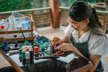 creative woman recycling plastic bottle waste, sustainability lifestyleの写真素材