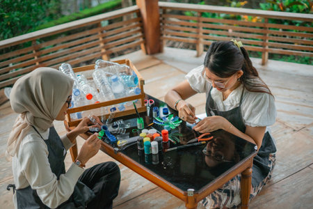 asian women making plastic bottle handcraft together at gazeboの写真素材